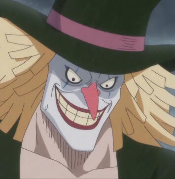 A character from One Piece. He wears a top hat with clown make-up and has blond straw-like hair. His expression is a large menacing grin.